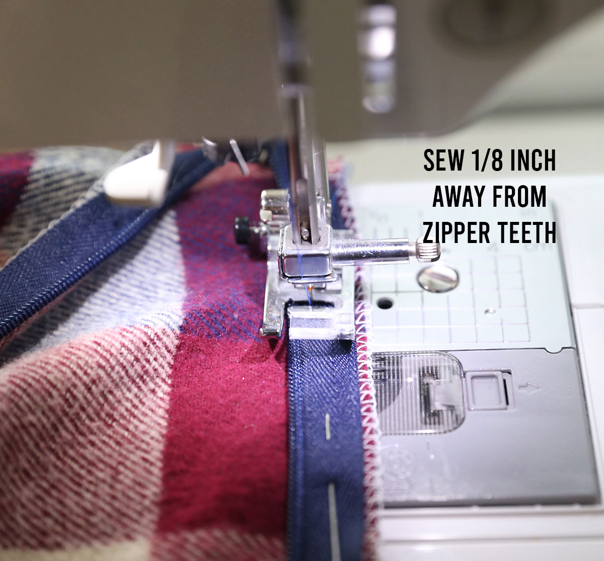 Sewing machine sewing the zipper to the raw edge of the skirt