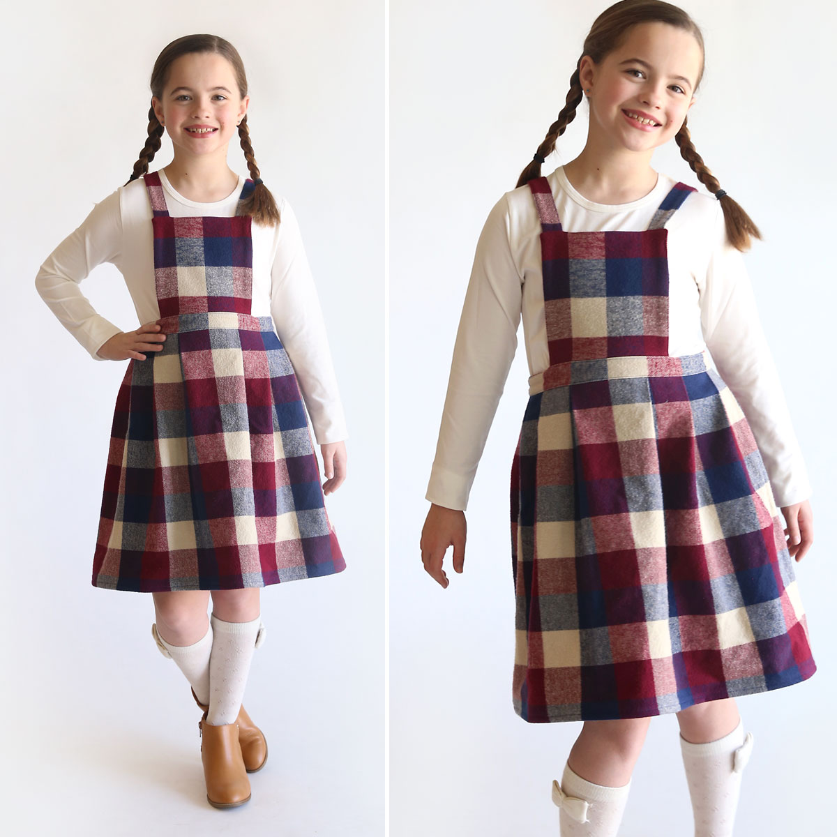 A girl wearing a plaid pleated pinafore dress