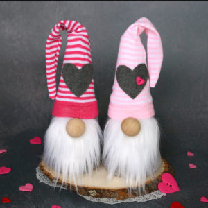 DIY sock gnomes with pink and white striped hats with hearts on them
