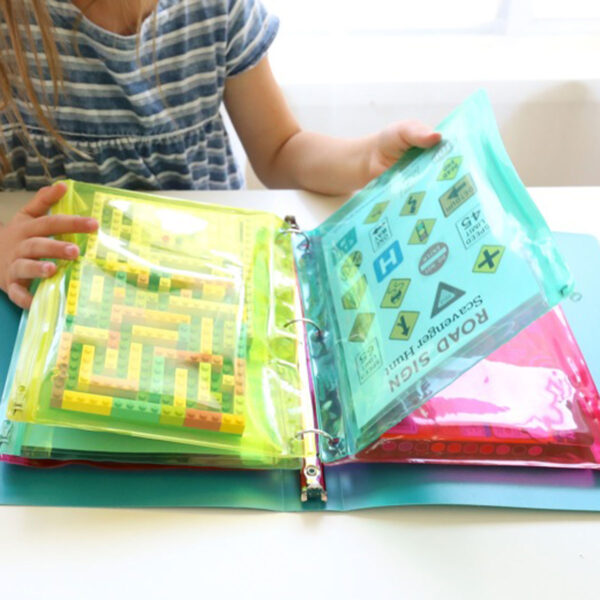 Kid looking through binder with plastic pouches.