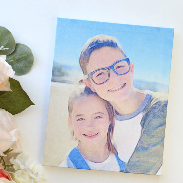 A photo of a boy and girl on a canvas next to flowers