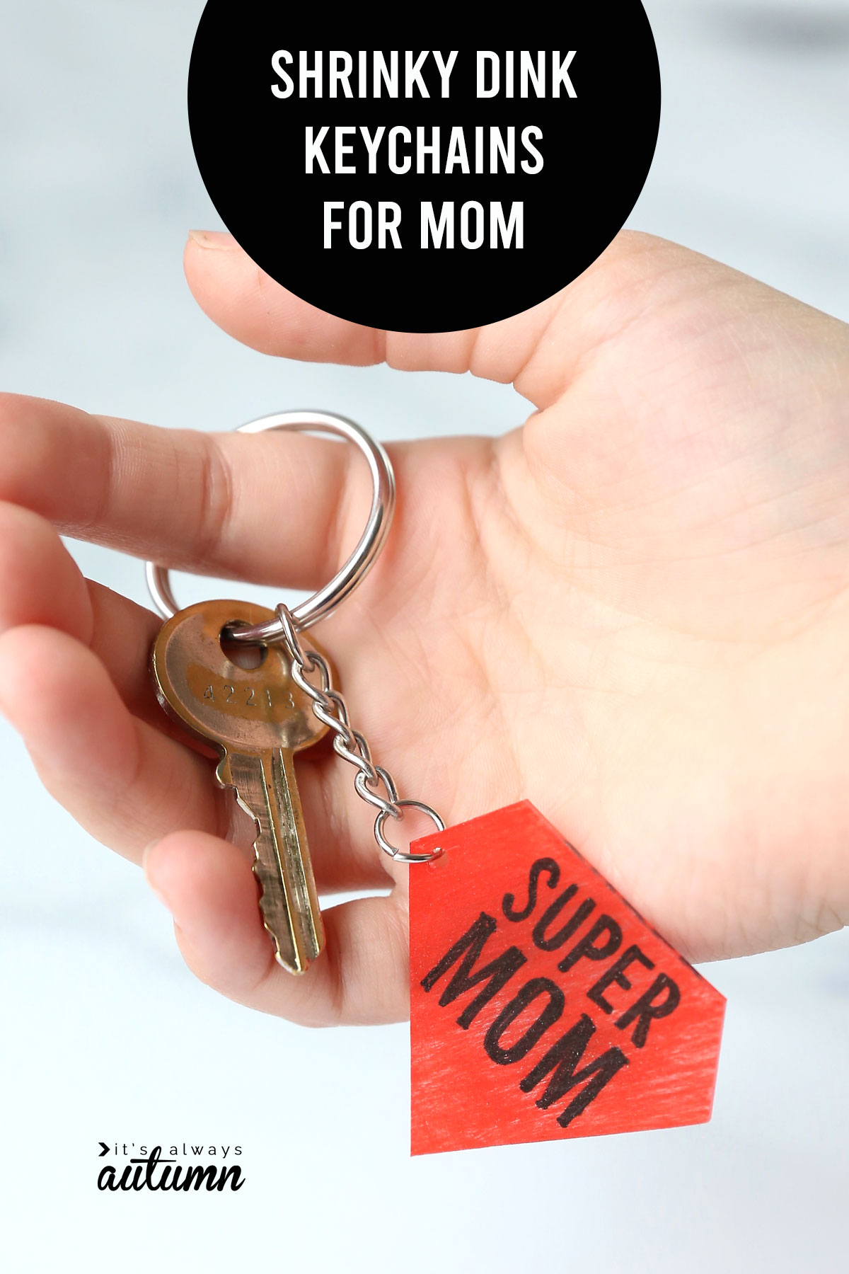 Hand holding key on a super mom keychain and words: shrinky dink keychain for mom