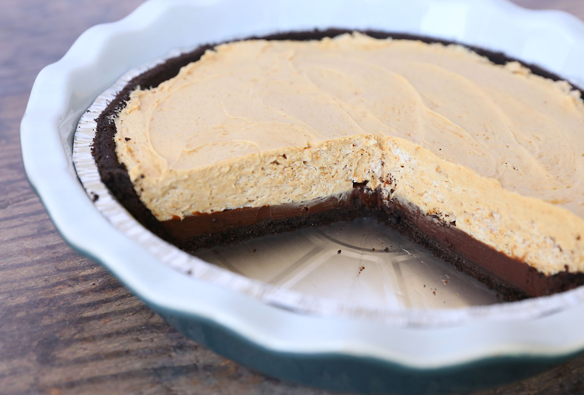 Pie with Oreo crust, chocolate ganache, and peanut butter cream layers