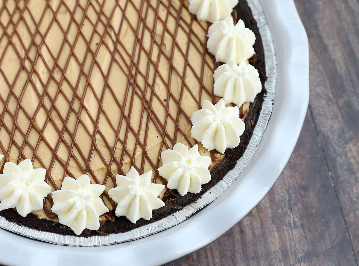 Pie with Oreo crust, chocolate ganache, and peanut butter cream layers