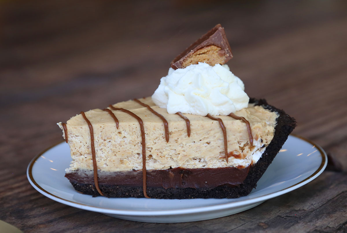 Pie with Oreo crust, chocolate ganache, and peanut butter cream layers