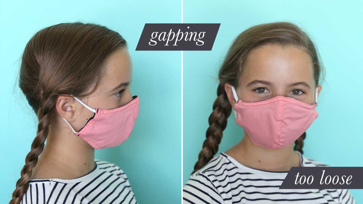 Girl wearing fabric face mask that is too large