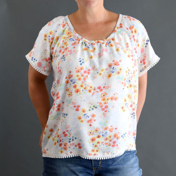 A woman wearing a gathered raglan blouse made from a free sewing pattern