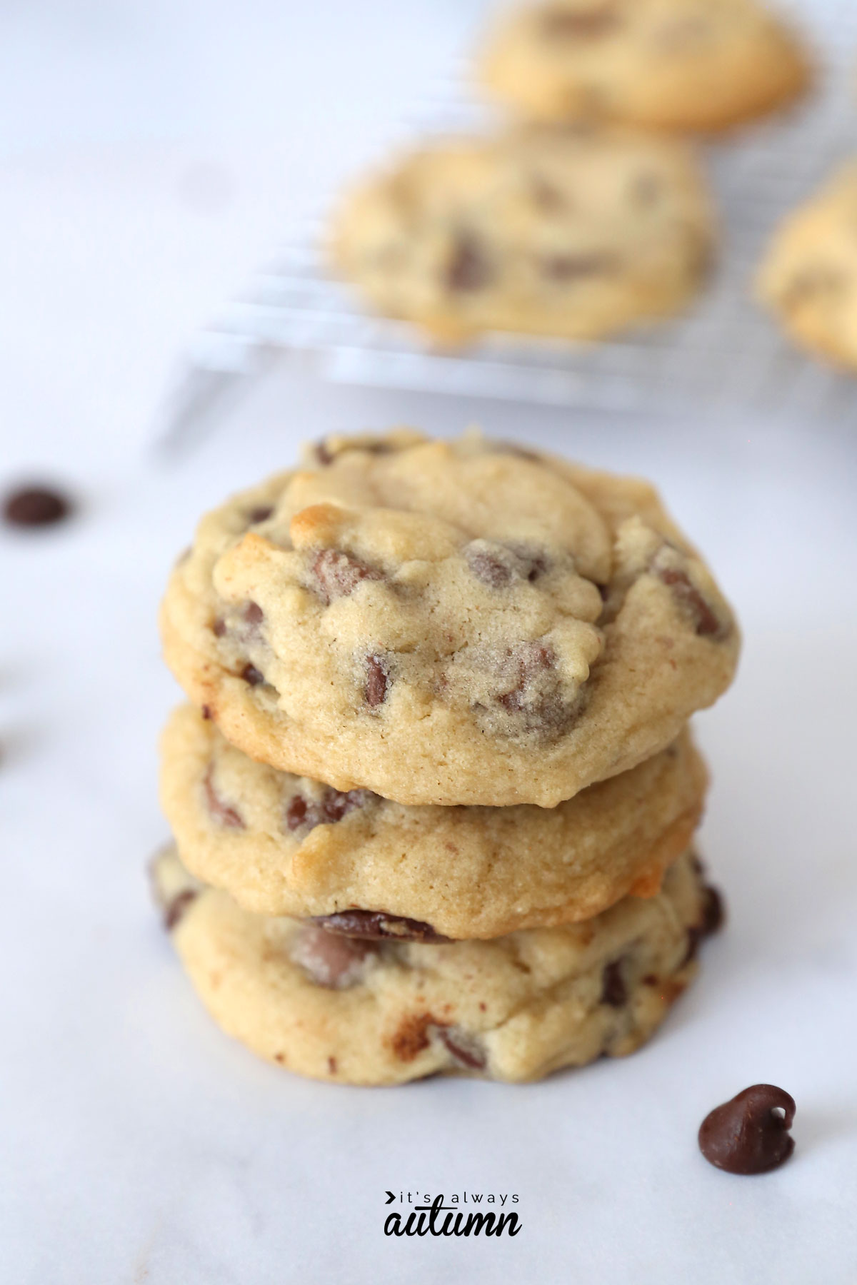 A close up of a stack of soft chocolate chip cookies