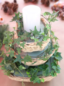 Faux ivy strands wrapped around centerpiece