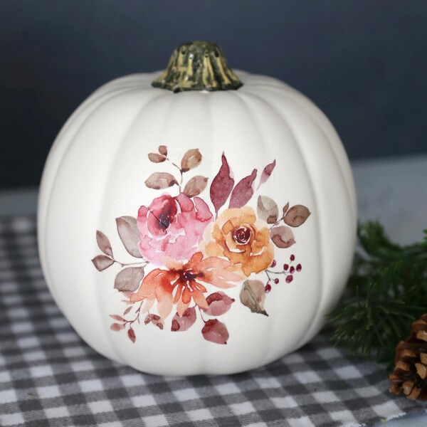 White craft pumpkin with fall floral design transferred onto it