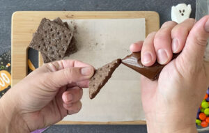 Use melted chocolate to glue graham cracker pieces together