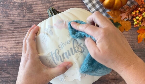 Use a damp cloth to wet the paper