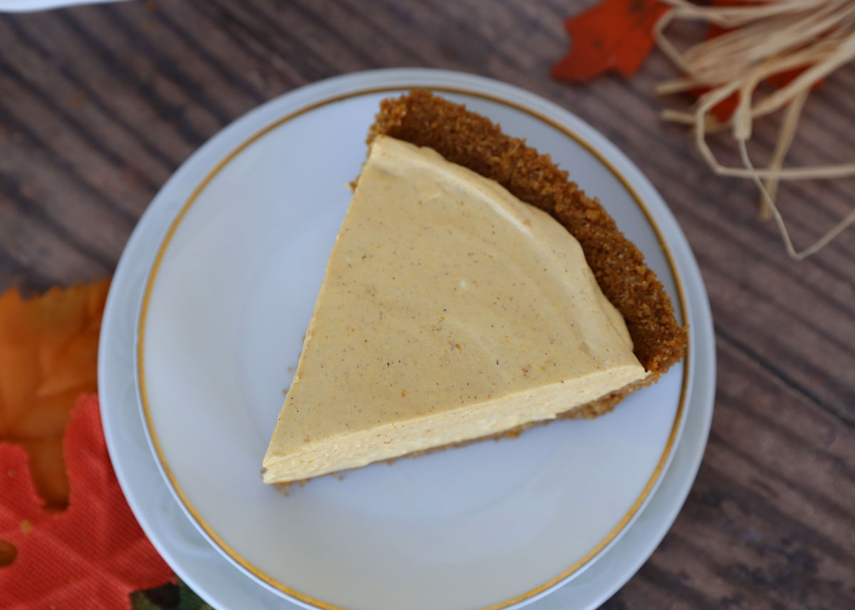 Slice of no bake pumpkin cheesecake on a white plate