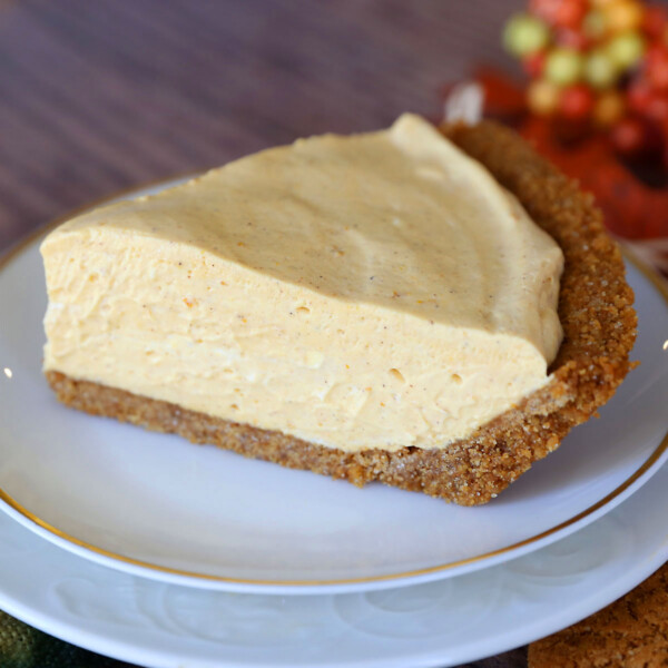 Slice of no bake pumpkin cheesecake on a white plate