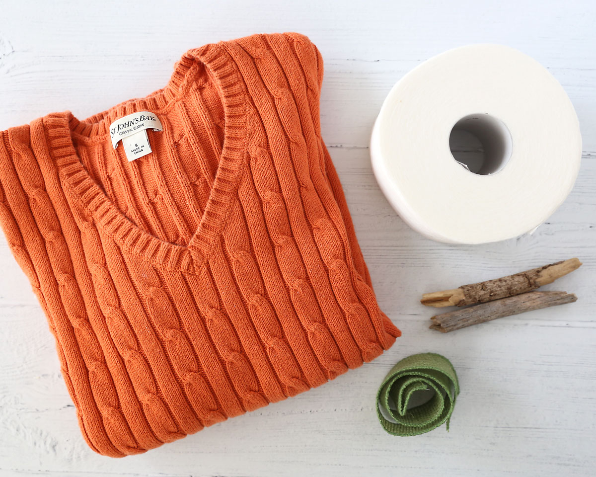 Supplies: Sweater, toilet paper, sticks, green ribbon