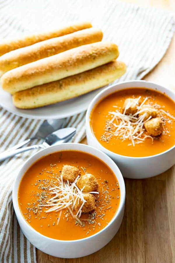 Tomato soup with croutons and breadsticks.