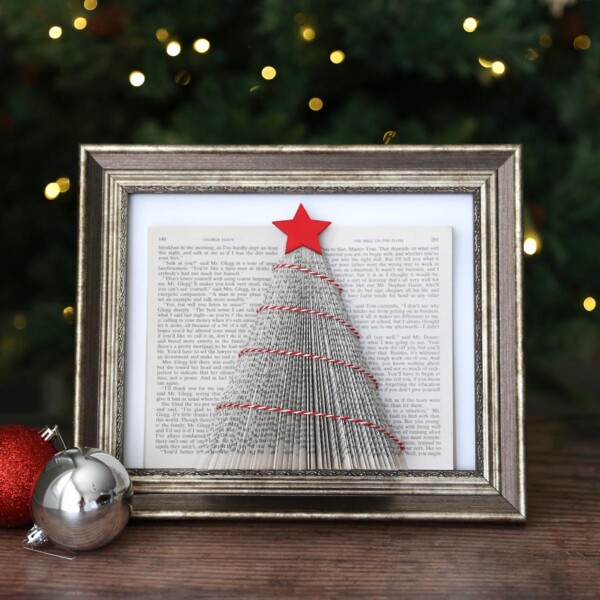Christmas tree made from a book with folded pages in a picture frame