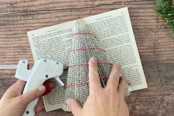Folded book Christmas tree: hot glue gun attaching twine