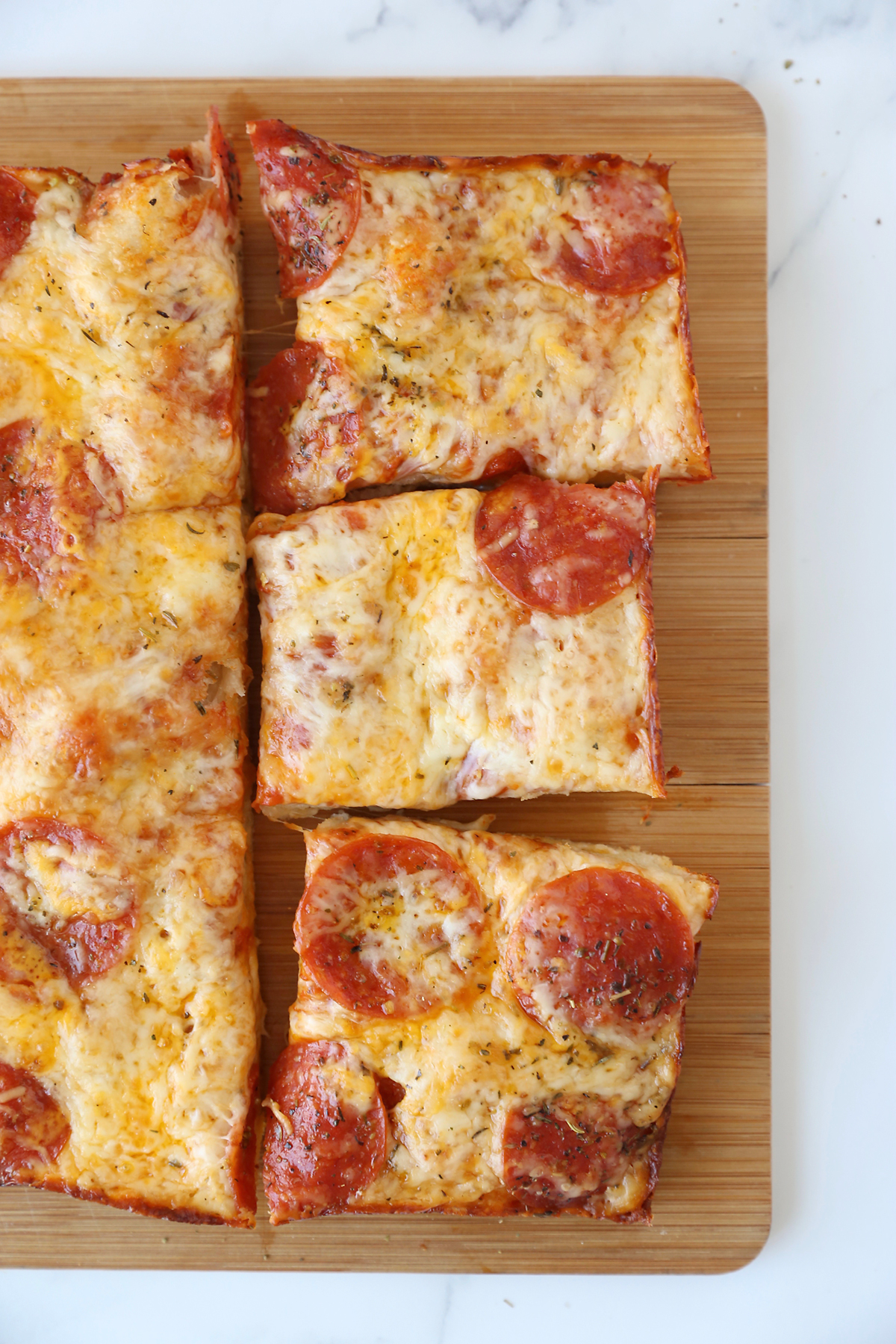 Thick crust pan pizza on a cutting board