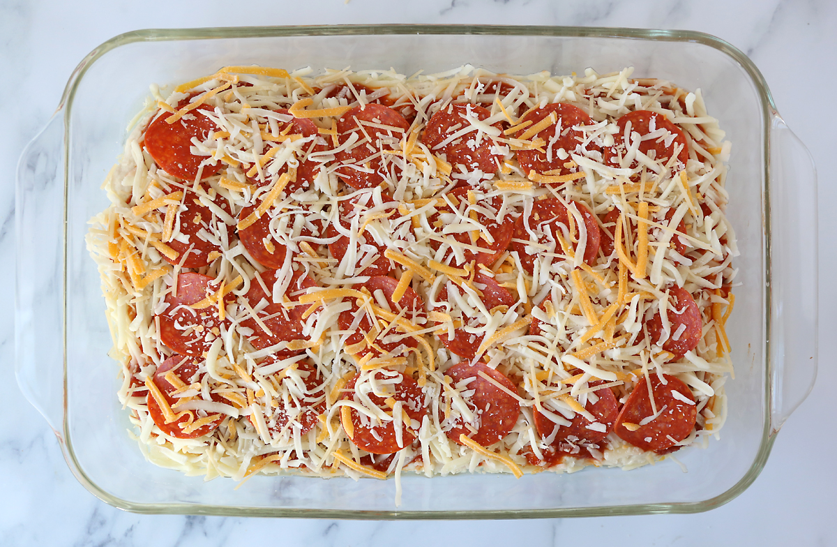 Deep dish pizza dough topped with sauce, cheese and pepperoni