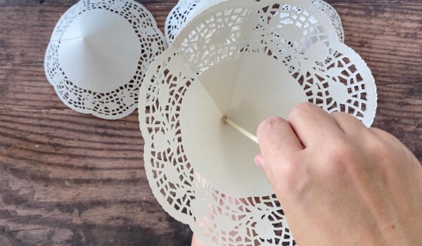 Slide largest doily cone down to hot glue