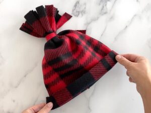 Completed fleece hat with fringed pom pom top