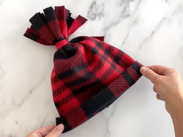 Completed fleece hat with fringed pom pom top