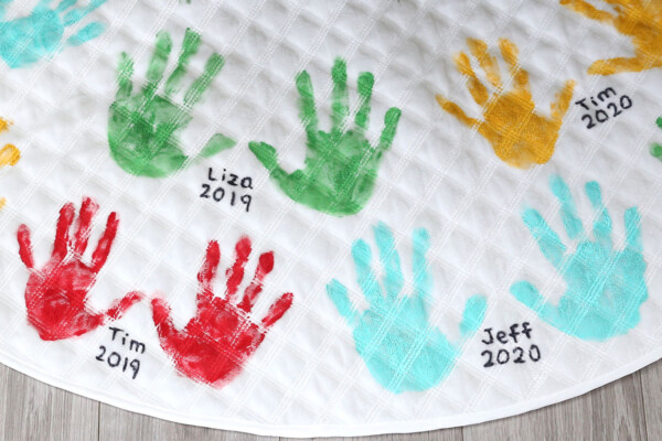 Cute handprint Christmas tree skirt with names and dates written by handprints