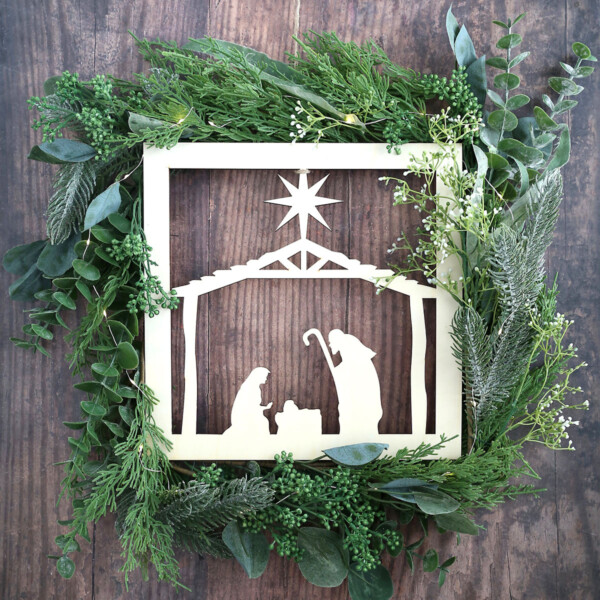 You can make this gorgeous DIY Nativity Wreath by combining an inexpensive nativity cutout with greenery