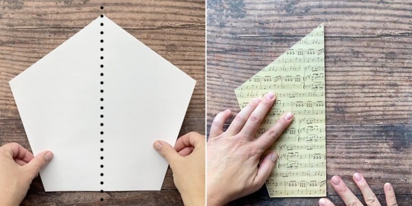 Hands folding paper pentagon in half right to left
