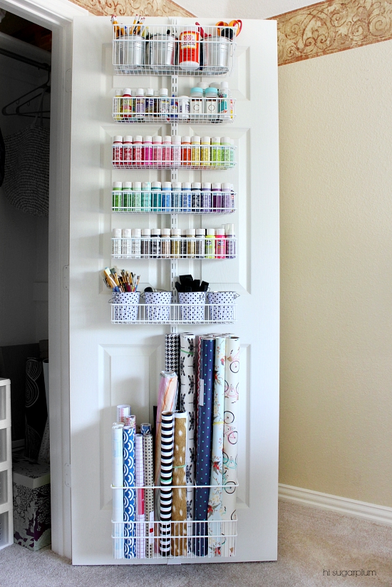 Wire organizer hanging inside a closet door filled with craft supplies