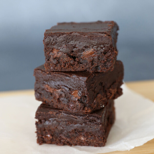 Stack of fudgy chocolate brownies on a cutting board