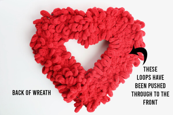 Back of heart wreath covered in loop yarn; on the right side all the loops have been pushed to the front
