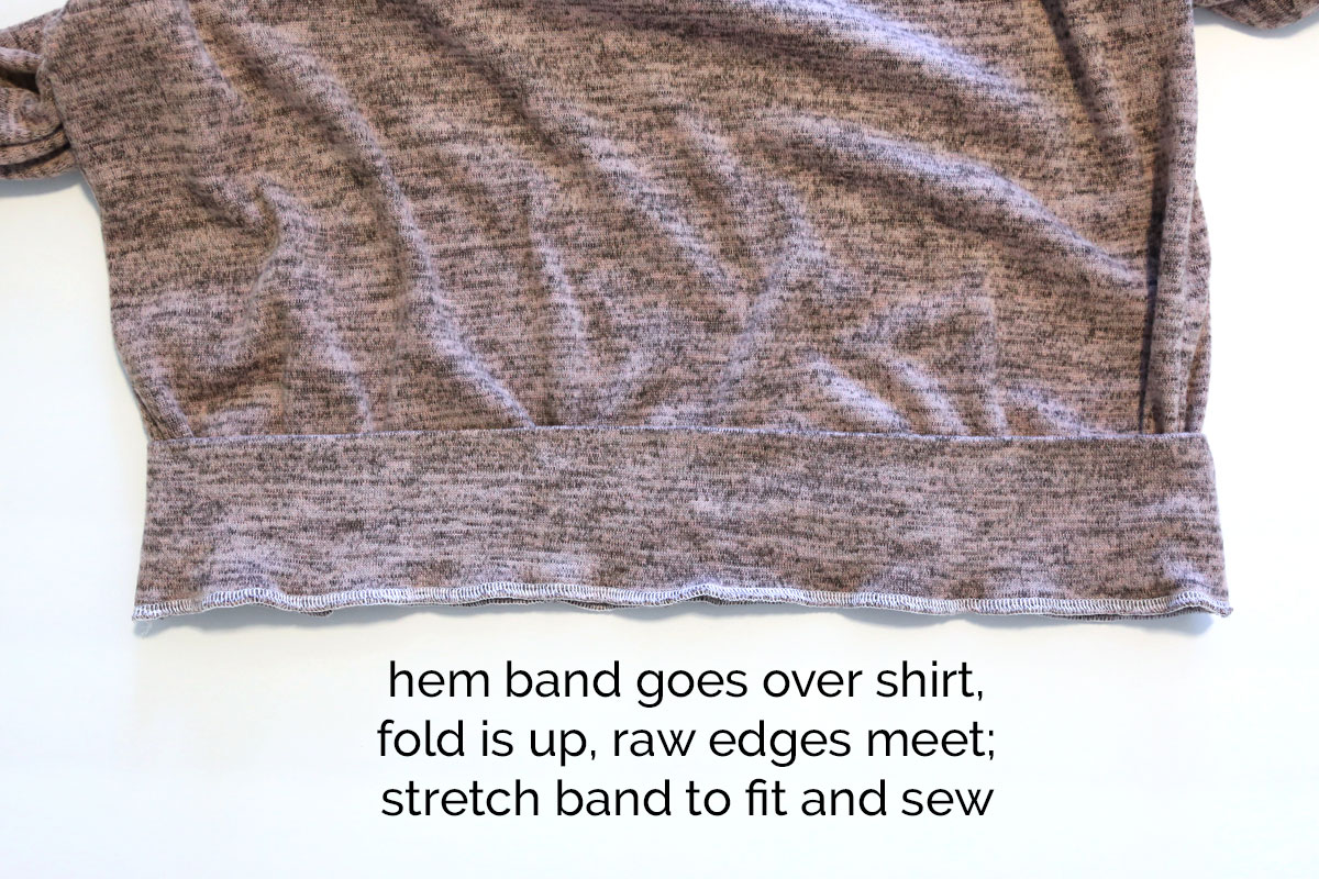 Hem band placed over bottom of shirt and sewn on