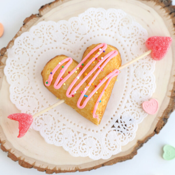 Twinkie heart with arrow through it and frosting and sprinkles on top