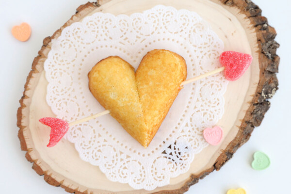 Twinkies cut to form heart shape with arrow through it made from skewer and jelly hearts