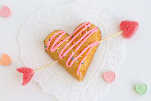 Twinkie heart with arrow through it and frosting and sprinkles on top