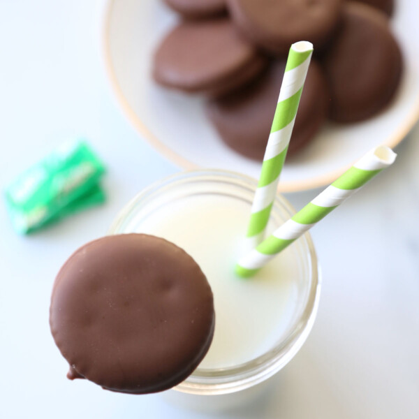 Homemade thin mint cookie balanced on glass of milk