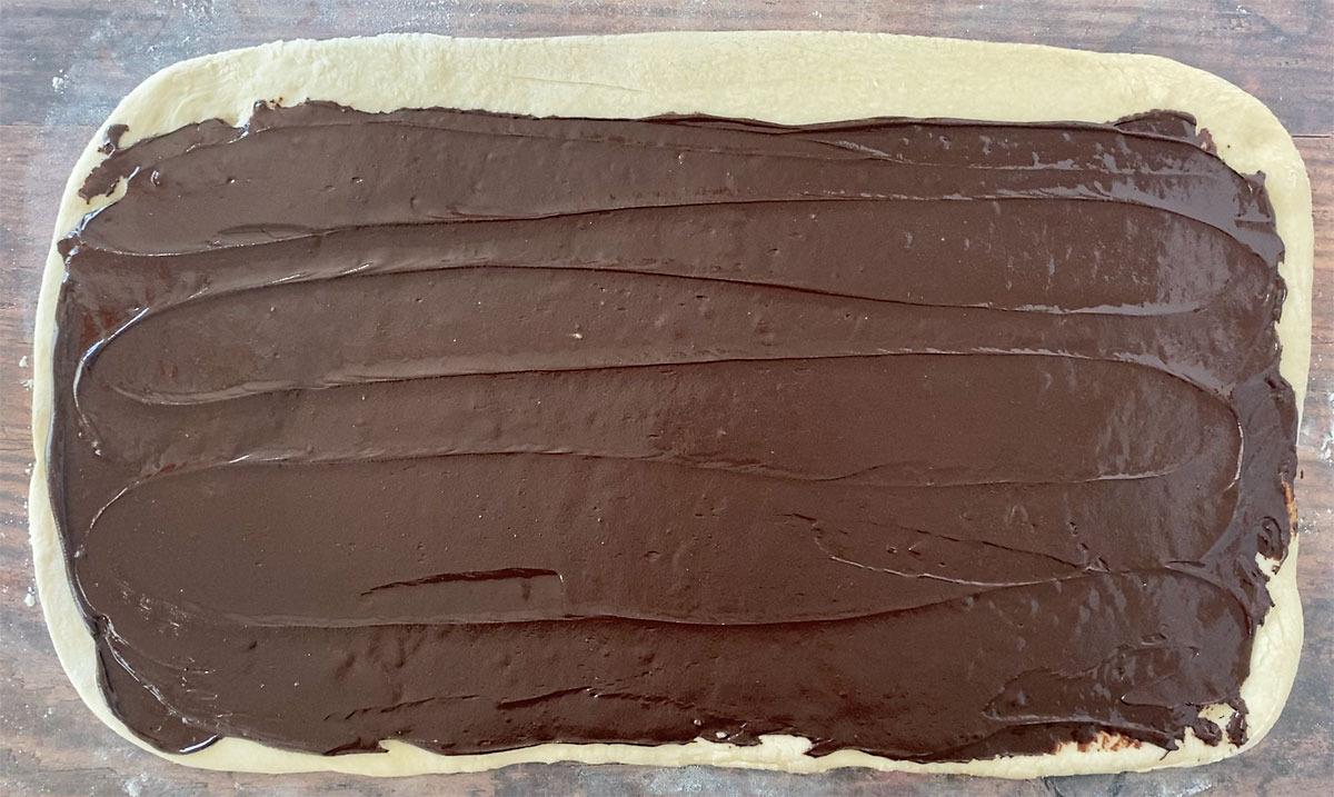 Rectangle of bread dough spread with chocolate babka filling