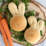 Dinner rolls in the shape of a bunny with carrots and herbs