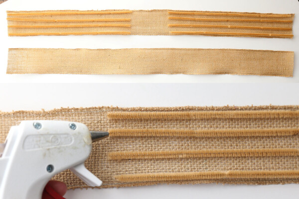 Two strips of burlap ribbon with four pipe cleaners laid on either side; hot glue gun to glue pipe cleaners to ribbon