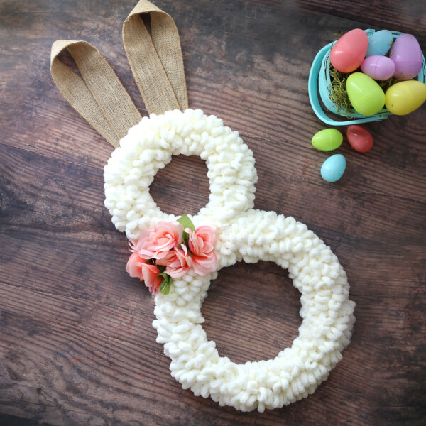 Easter bunny wreath made from cream loop yarn with burlap ribbon ears
