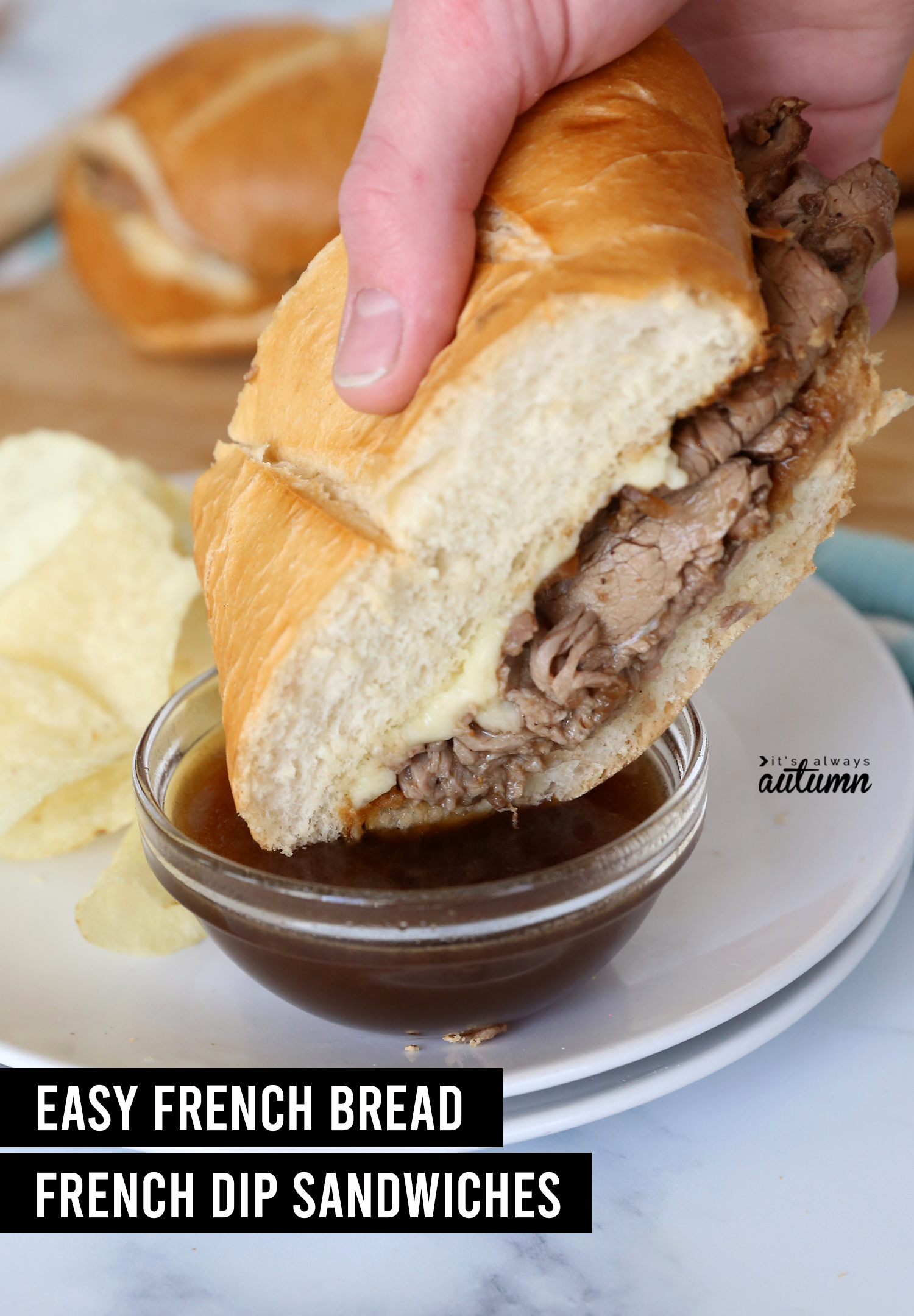 Hand dipping roast beef sandwich into au jus with words: easy french bread french dip sandwiches