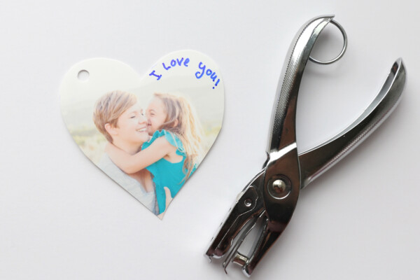Picture of a girl and her mom printed on shrink film, with keychain attachment and hole punch