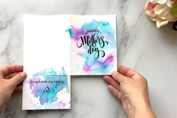 Card template opened flat; bottom right quarter has been cut away; bottom left section has been cut away