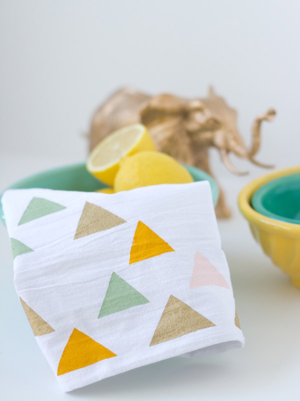 Geometric painted tea towel in a bowl with lemons