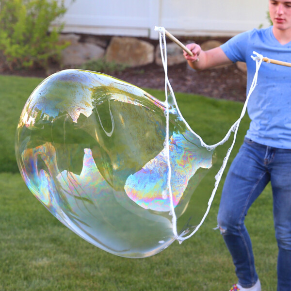 Boy blowing large bubble