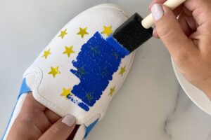 Painting over star stickers on the top of a canvas shoe