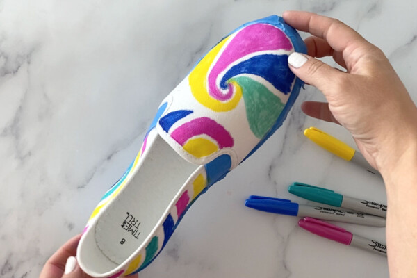 Canvas shoe with swirl designs drawn on it