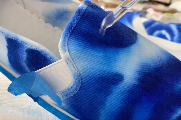 Closeup of shoe being tie dyed with Sharpie and alcohol
